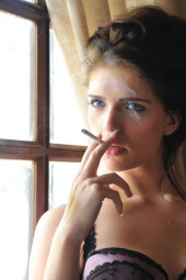 Smoking girl in sexy lingerie does deep inhales